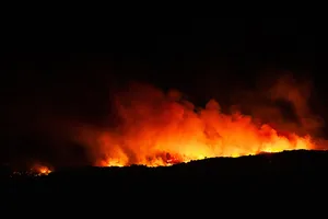 This photograph shows a wildfire burning in the Aspres region forcing the evacuation of many villages, near Millas, in the Pyrenees-Orientales department, southern France on July 5, 2026. A wildfire broke out on July 4 at around 19h30 (1730 GMT) in a hard-to-reach massif near Trevillach, in the Pyrenees-Orientales department of southern France and spread rapidly overnight. More than 10,000 residents are currently being evacuated as the wildfire spreads rapidly, having burned around 2,000 hectares. (Photo by Jean-Christophe MILHET / AFP via Getty Images) This photograph shows a wildfire burning in the Aspres region forcing the evacuation of many villages, near Millas, in the Pyrenees-Orientales department, southern France on July 5, 2026. A wildfire broke out on July 4 at around 19h30 (1730 GMT) in a hard-to-reach massif near Trevillach, in the Pyrenees-Orientales department of southern France and spread rapidly overnight. More than 10,000 residents are currently being evacuated as the wildfire spreads rapidly, having burned around 2,000 hectares. (Photo by Jean-Christophe MILHET / AFP via Getty Images)