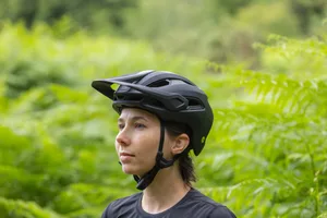 Specialized Ambush 3 trail helmet Specialized Ambush 3 mountain bike helmet in black photographed with ferns in the backgroud.