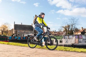 Van Moof X3 – 04 Male cyclist in yellow top riding the Van Moof X3 electric commuter bike