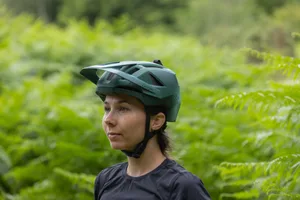 Lazer Impala KinetiCore review Rider wearing the Lazer Impala KinetiCore trail mountain bike helmet in woodland.
