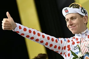 TOPSHOT-CYCLING-TDF-2026-STAGE 14 TOPSHOT - UAE Team Emirates - XRG's Slovenian rider Tadej Pogacar celebrates on the podium with the best climber's polka dot (dotted) jersey after the 14th stage of the 113th edition of the Tour de France cycling race, 155,3 km between Mulhouse and Le Markstein in the Vosges mountains, on July 18, 2026. (Photo by Loic VENANCE / AFP via Getty Images)