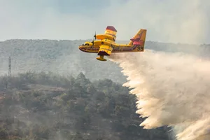 FRANCE-FIRE A Canadair CL-415 water bombing aircraft of France's Civil Security services drops water on a wildfire in the southern France departmennt of Pyrenees-Orientales where 700 hundred firefighters backed by special aircraft battled to control a "gigantic" blaze spreading in a hard-to-reach remote area, with more than 10,000 local residents evacuated, near the town of Bouleternerre on July 6, 2026. Wildfires raged across southern Europe, forcing thousands of people to evacuate their homes and prompting officials to ban spectators from a stage of the storied Tour de France cycling race. (Photo by Jc Milhet / AFP via Getty Images)