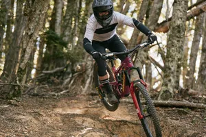 RockShox ZEB Ultimate ride shot 2 Rider in full face helmet descending through the trees and turning. Riding on Santa Cruz bike with RockShox ZEB fork.