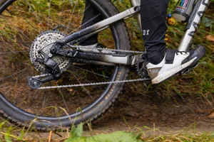 Shimano Deore M7200 drivetrain on a smooth trail Close-up of a Shimano Deore M7200 drivetrain in use on a mountain bike, showing the rear derailleur, cassette and chain.