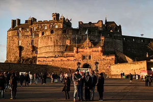 BRITAIN-SCOTLAND-NEW YEAR This general view shows tourists outside Edinburgh Castle on December 30, 2025, ahead of the annual Hogmanay street party which culminates in a midnight fireworks display over the castle. An estimated 100,000 people from dozens of countries are expected in Edinburgh for the New Year events, the centrepiece of which is a street party and fireworks display on December 31. (Photo by Andy Buchanan / AFP via Getty Images)