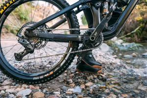 Shimano Deore XT M8200 mechanical drivetrain Close-up of a Shimano Deore XT M8200 mechanical drivetrain fitted to a full-suspension mountain bike beside a stream.