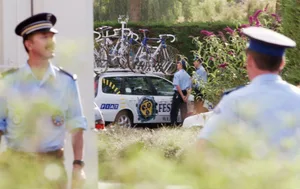 1998 Tour de France CHOLET - JULY 15: Policemen stay nearby Festina team sportive director Bruno Roussel's car in Cholet, West of France on July 15, 1998 as he is questioned about doping. (ELECTRONIC IMAGE) (Photo by JOEL SAGET/AFP via Getty Images)