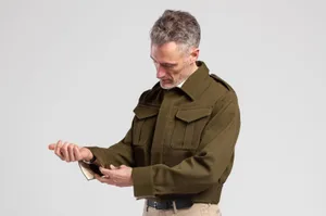 2bd1b622-36f7-4fd2-a34a-f88572f57bc8 A man wearing the AVRE battle jacket adjusting the cuff