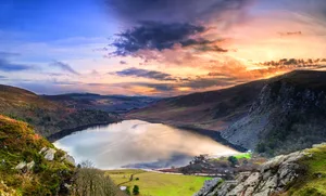 Dramatic sunset at Lake Lough Tay or The Guinness Lake in County Wicklow Dramatic sunset at Lake Lough Tay or The Guinness Lake in County Wicklow where Vikings village, Kattegat was located, Wicklow Mountains, Ireland.