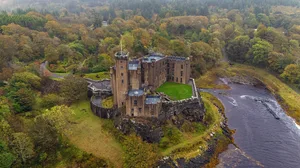 Dunvegan castle Scotland Aerial view Isle of Skye Scotland UK: October 10th of 2023 Dunvegan Castle is a remarkable piece of Scottish history and the oldest continuously inhabited castle in Scotland, having been the ancestral home of the Chiefs of Clan MacLeod for 800 years. Located on the Isle of Skye, the castle is built on a rock overlooking an inlet on the eastern shore of Loch Dunvegan