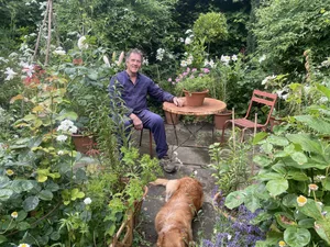 572844 Monty Don sat in his garden with his dog