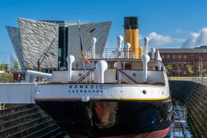 the HMS Nomadic in its dry-dock and the Titanic Museum in Belfast Belfast, United Kingdom - 21 August, 2022: the HMS Nomadic in its dry-dock and the Titanic Museum in Belfast