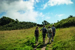 Father and teenage kids hiking on the hills of of Jurassic Coast in Dorset, United Kingdom Father and three teenage kids are hiking in Dorset, United Kingdom. They are walking on the grassy hills by the sea. (Photo: Imgorthand via Getty)