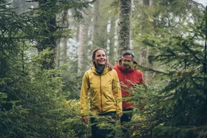 trail-walkers-final Mature couple hike through forest on a rainy day.