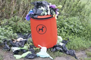 Dog waste bin A dog garbage bin overflowing with rubbish bags