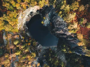 Overhead view of Hodge Close Quarry in Autumn Yellow birch trees surrounding the flooded Hodge Close Quarry