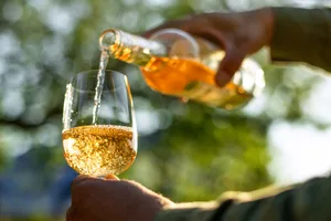 Orange wine Orange wine being poured into a glass