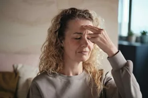 EFT-tapping Photo of a woman with two fingers placed on her temple