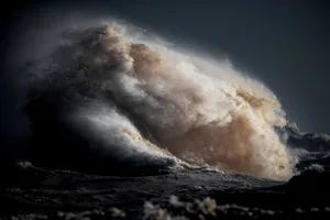 Large wave in Lake Erie A large body of water appears to erupt or explode in Lake Erie