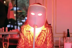 red-light-therapy-caveats Photo of a person sat behind a creepy-looking glowing red-light therapy mask