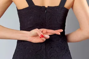 Woman fingers crossed Woman fingers crossed behind back