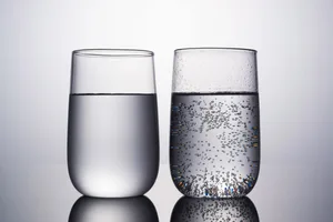 sparkling and still water two glasses of water, one has bubbles and the other is still