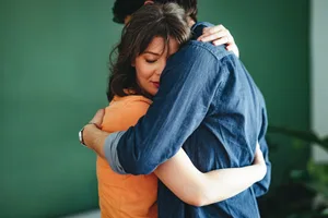 hugging grief Upset man and woman hugging.