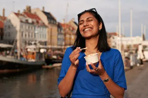 woman smiling with food Woman smiling walking with food.