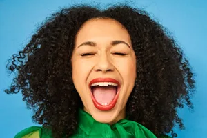 Mouth A woman wearing lipstick opens her mouth wide