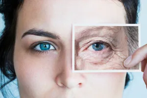 ageing-genetics Young woman with photo of aged eye over her own