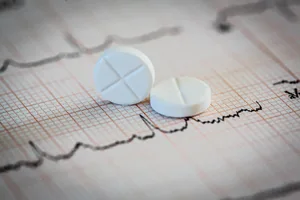statins-cholesterol Photo of two statin drugs on a piece of paper showing a heart scan.