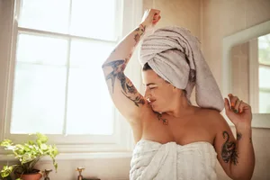 how-can-i-find-out-i-smell Photo of a person in bath robes sniffing their armpit