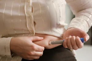 GLP-1-body-changes Person injecting semaglutide in her abdomen