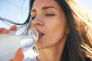 woman drinking bottled water Woman drinking water