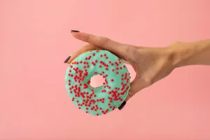 woman holding donut