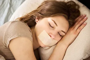 woman sleeping Woman sleeping with tape on mouth.