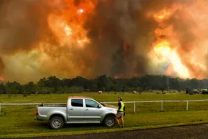 fire-thunderstorms Locals watch as bushfires impact on farmland near the small town of Nana Glen, some 600kms north of Sydney on November 12, 2019