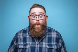 Man with beard looking surprised by fun facts. Man with beard looking surprised by fun facts.