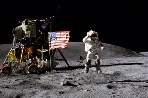 apollo-landing Astronaut on surface of the Moon next to American flag.