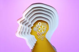 Dementia mind Multi layered head silhouette with gears inside on yellow background. Illustrating dementia