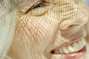 Smiling woman A close-up of a smiling woman under textured shadow