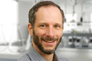 Prof Kai Udert A scientist smiling at the camera, with a laboratory in the background
