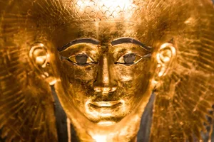Mummy (1) A shiny golden replica model of an ancient Egyptian pharoah sarcophagus