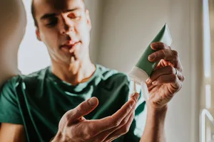 cream Man putting cream on hand