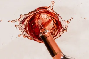 alcohol being poured away Close up of an artistic rosé wine spill