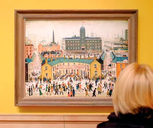 Woman in front of a painting by LS Lowry Painting by LS Lowry