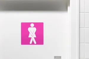 Incontinence A bathroom door sign of a woman needing the toilet