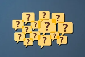 Questions to ask yourself A group of speech bubbles containing question marks against a blue background