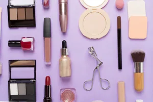 Makeup mistakes An assortment of cosmetic items on a purple background