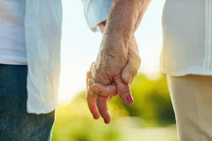 An elderly couple holding hands An elderly couple holding hands